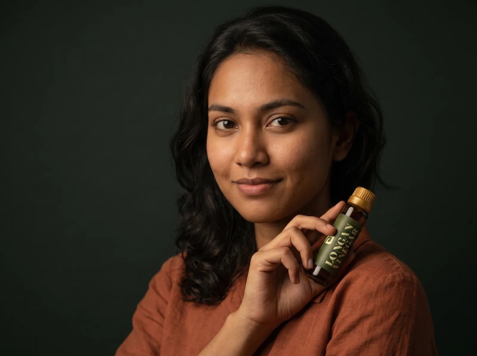 Woman holding a bottle of Longan Vinegar